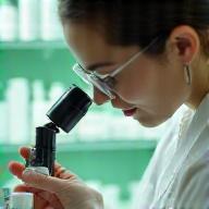 Technician inspecting skincare samples